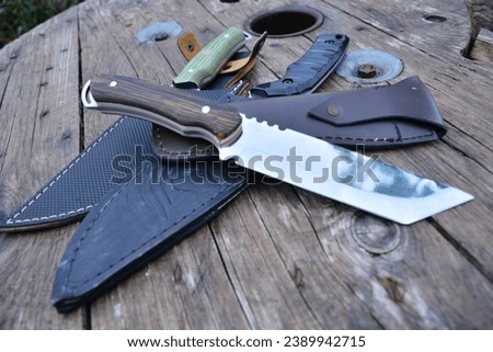 Hunting knives are tasteful handmade knives with their sizes, shapes and sheaths. Royalty-Free Stock Photo #2389942715