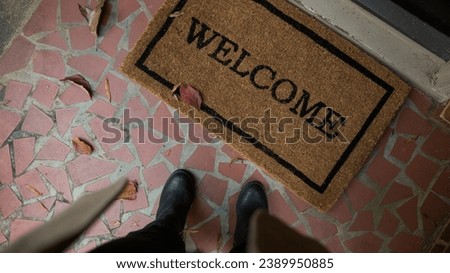 a person stand at the welcome sign top view Royalty-Free Stock Photo #2389950885