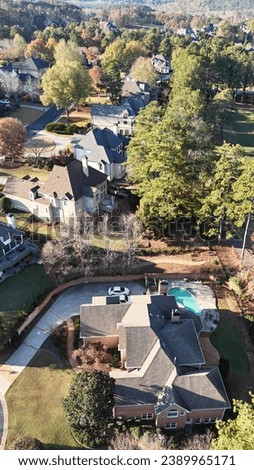 Aerial panoramic view of an upscale subdivision in suburbs of Atlanta shot during golden hours in fall of 2023
