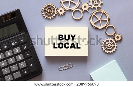 BUY LOCAL text written on sticky on grey background.