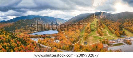 Aerial panorama of Franconia Notch State Park, the slopes of Mount Lafayette and Mount Cannon ski resort, above Echo Lake, in the fall season, in New Hampshire Royalty-Free Stock Photo #2389982877