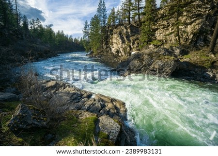 Spokane River during spring runoff in Post Falls Idaho Royalty-Free Stock Photo #2389983131