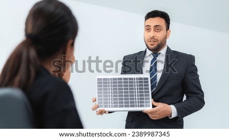 Business man presenting solar panel to her colleagues during business meeting at Business man presenting solar panel to her colleagues during business meeting at office
