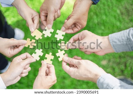 Coworker's hand holding jigsaw puzzle With the cooperation of business people team joins together to campaign Environment, Society and Corporate Governance. Sustainable corporate social, environmental Royalty-Free Stock Photo #2390005691