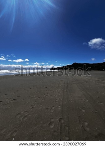 Long empty beach with footsteps