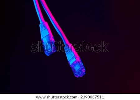 Modern technology network cable in neon light. Royalty-Free Stock Photo #2390037511