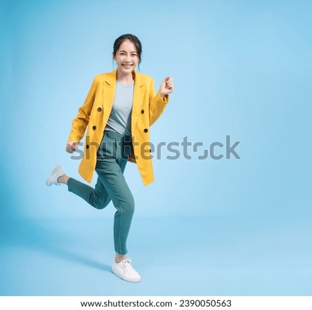Photo of young Asian businesswoman on background Royalty-Free Stock Photo #2390050563