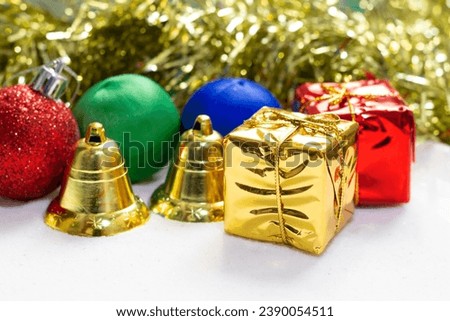Material Christmas tree decorations on white glass sand background