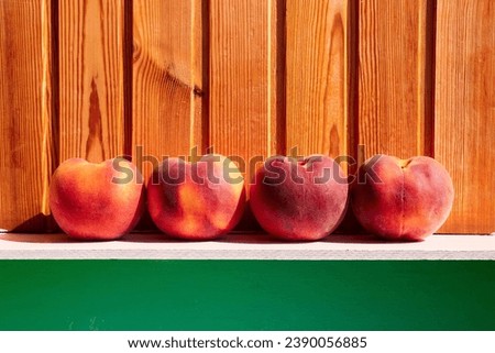 Ripe bright peaches on the background of a wooden wall. Bright colors.