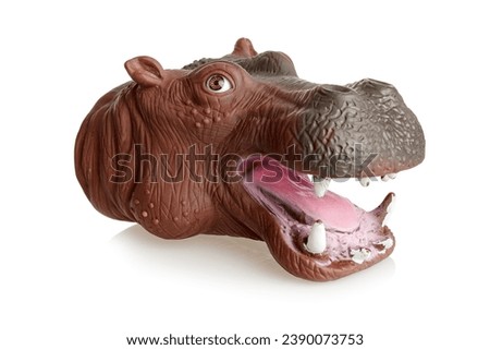Glove doll with an opening mouth, a toy on the hand in the form of a hippo, isolated on a white background
