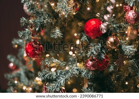 Chirstmas tree and lights and background. gold Red bobble decoration Royalty-Free Stock Photo #2390086771