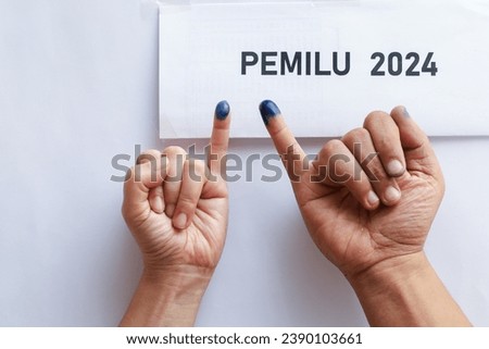 indonesian election 2024 concept.  finger with an ink mark on the little finger.indonesian election 2024 concept.  finger with an ink mark on the little finger.  presidential election in Indonesia Royalty-Free Stock Photo #2390103661