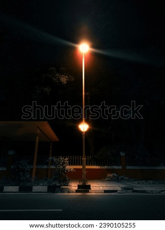 Street light illuminating with nature background Royalty-Free Stock Photo #2390105255