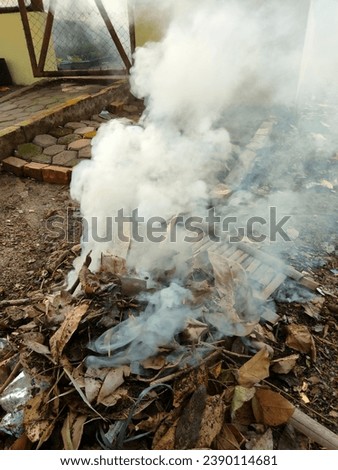 Smoke from burning garbage in the yard