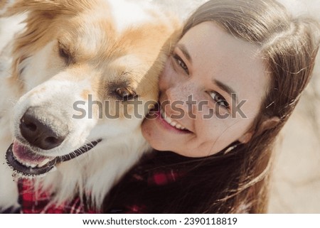 Brunette Kissing her Large brown and white dog
