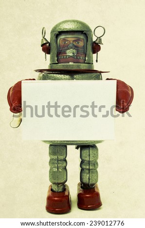 robot toy holding a sign 
