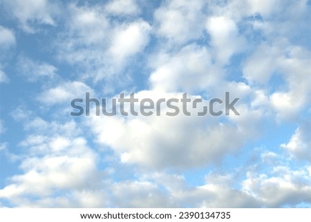 Background material of light blue sky and fluffy cute clouds.