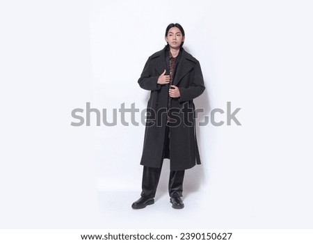 Full body portrait of handsome male wearing striped coat ,khaki pants posing on white background Royalty-Free Stock Photo #2390150627