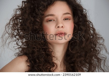 Portrait of a cute girl with lush curls.