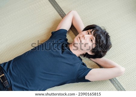 Young man lying on tatami mats