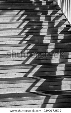 Old Wooden Stairway and Railing in Sunlight with Shadow.