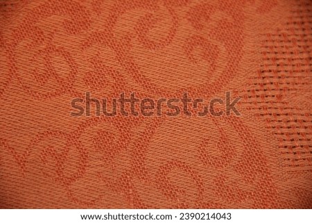 Bright orange fabric with a light pattern. Backgrounds
