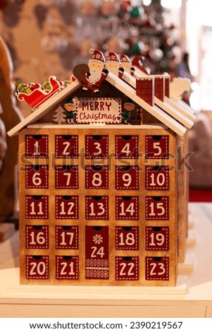 christmas advent calendar in shape of a house with santa claus