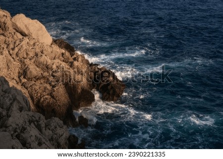 Waves beat against the coastal sea rock