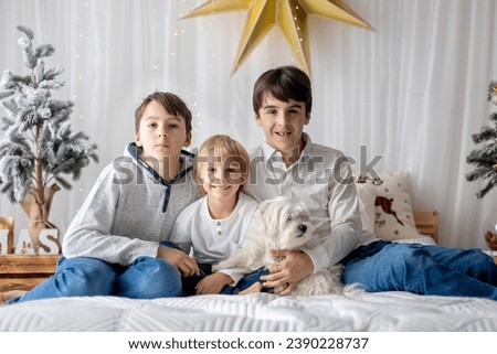 Happy family, children, taking family pictures in a cozy christmas studio together