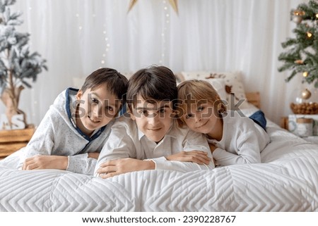 Happy family, children, taking family pictures in a cozy christmas studio together