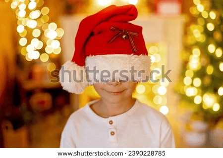 Happy child, boy, having pictures taken in a cozy christmas studio, childhood, happiness