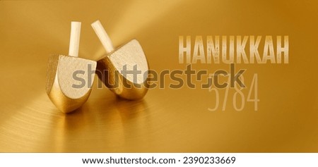 Jewish holiday Hanukkah with wooden dreidels (spinning top). Golden baner Royalty-Free Stock Photo #2390233669