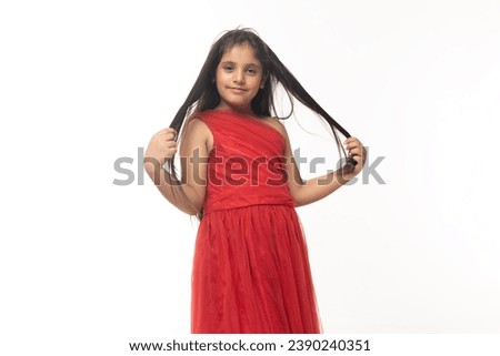 Portrait of cute happy smiling Indian girl child wearing traditional red dress short sleeve costume. showing hands expressions. Asian female kid looking at camera.  isolated on white background.