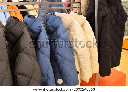 Women's winter insulated jackets in the store Royalty-Free Stock Photo #2390248353