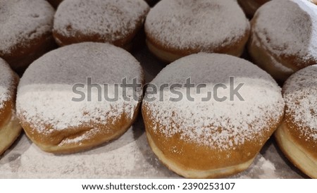 round dough donuts with jam, sufganiyet, Jewish Hanukkah dessert, custom food. High quality photo Royalty-Free Stock Photo #2390253107
