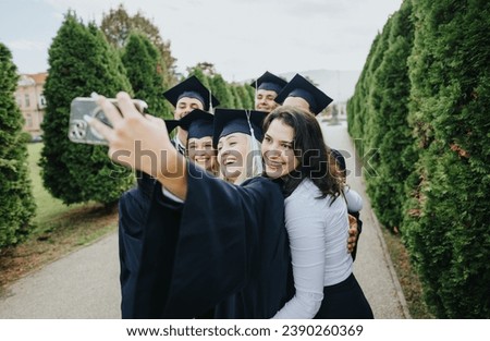 Graduates in caps and gowns celebrate their achievements, taking selfies with friends and faculty in a park. Happy memories of a successful graduation day.