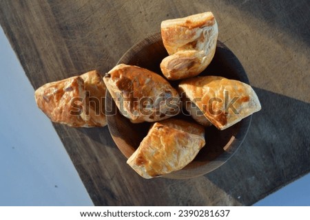 Delicious fresh puff pastry on the wooden table, seen from above