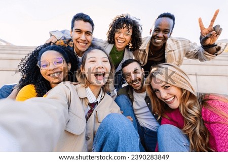 Young community of diverse happy student friends taking selfie portrait together. Millennial group of people having fun enjoying free time outdoors. Youth, diversity and friendship concept. Royalty-Free Stock Photo #2390283849