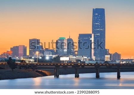 Oklahoma City, Oklahoma, USA downtown skyline on the Oklahoma River at dawn.