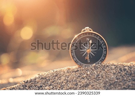 Travel of tourists with compass. compass of tourists on sandy beach. Royalty-Free Stock Photo #2390325339