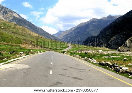 The isolation of this mountain road provides a unique experience, allowing travelers to immerse themselves in the untouched beauty of the natural landscape.  Royalty-Free Stock Photo #2390350877