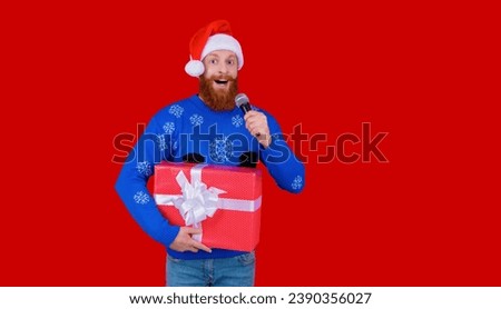 New Year holiday shopping sale. Happy 2024 New Year. Christmas shopping sale. Xmas sale announcement. Santa man with microphone and gift isolated on red. Christmas present. Copy space