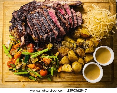 Picture of medium rare dinner steak with boiled potato