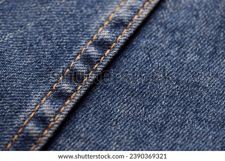 Seams on jeans close-up. Stitching on denim. Fabric texture. Blue jeans background and texture. Close up of blue jeans background. Denim texture in high-resolution
