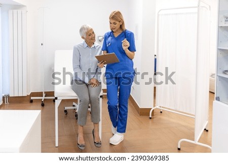 Senior woman, doctor and elderly patient with good news, tablet and results for health, advice and report. Happy medic, clipboard with smile, tech or support in hospital