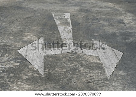arrow sign on concrete wall