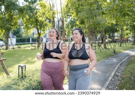 Happy plus size asian woman running in a park for health, wellness and outdoor exercise. Nature, sports and female athlete runner doing cardio workout in garden. Healthy Concept.