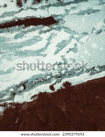 Flowing river at winter. Winter landscape with a River and Winter Forest. aerial view from icy river in winter. Selective focus.