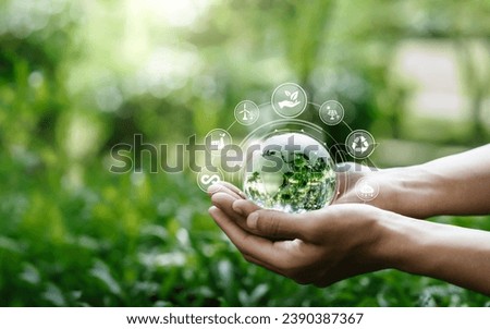 Hands protection globe on nature background with icon Environmental, renewable, sustainable energy, CO2, net zero, and ESG concept for low or neutral carbon. Ecology and Environment concept  Royalty-Free Stock Photo #2390387367