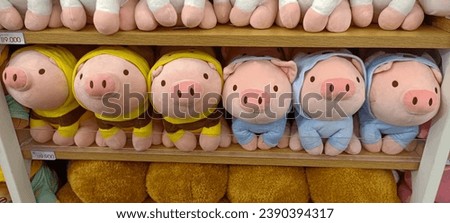 Several cute pig dolls are displayed on the shelves 